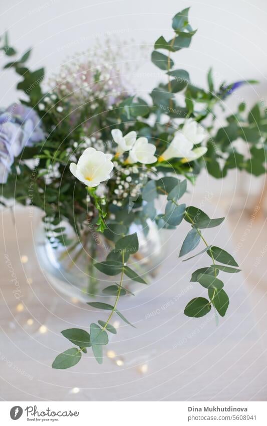 beautiful minimal bouquet with spring flowers and eucalyptus leaves. Fresh elegant home decor. Florist work. salon vase florist floristry leaf green minimalist