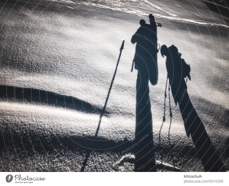 Shadow of father and son on a tour with snowshoes and snowboard Snowboard Snowboarder Winter Sports Snowboarding Winter sports hiken Snow hiking Tours