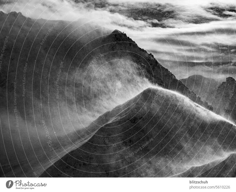 Stormy conditions on the mountain in the Swiss Alps Mountain Nature Landscape Peak mountains Clouds Sky Snowcapped peak Winter Rock Climate Weather Wind windy