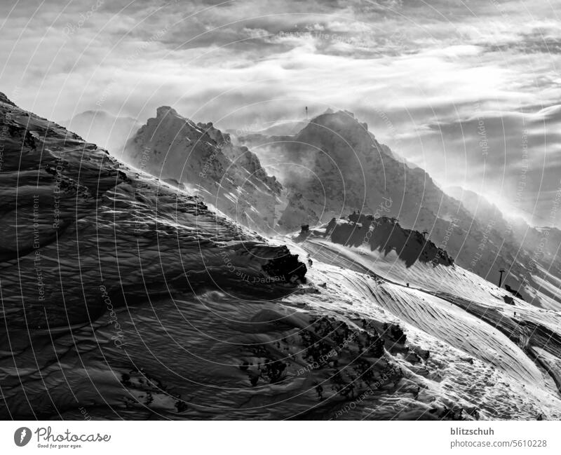 Stormy conditions on the mountain in the Swiss Alps Mountain Nature Landscape Peak mountains Clouds Sky Snowcapped peak Winter Rock Climate Weather Wind windy