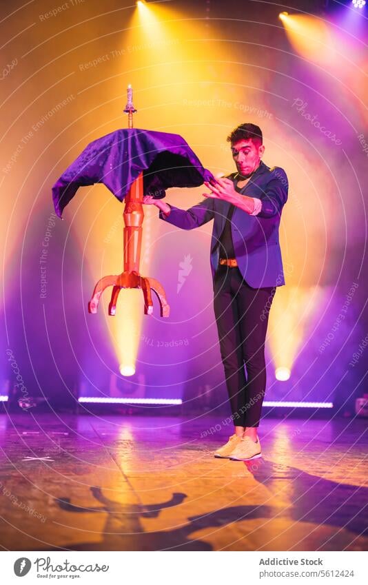 Professional magician performing trick with levitating table man show levitate fly illusion male performer conjurer illusionist stage mystery tablecloth smoke