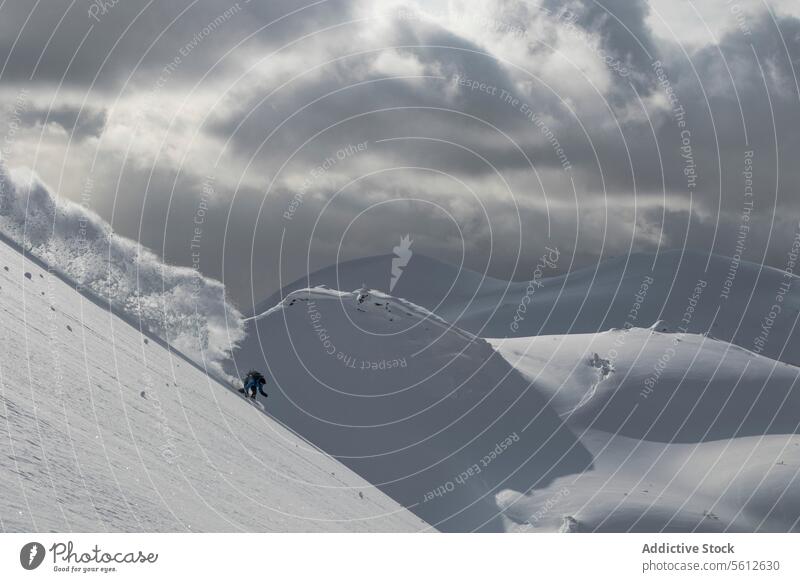 Skier skiing on snow covered slope in Japan person skier snowcapped mountain lake sky japan full body cloudy highland danger top pole warm clothes winter