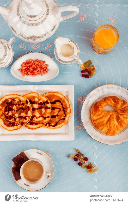 Elegant Continental Breakfast Spread on Blue Background breakfast continental blue background top view waffles fruit coffee juice elegant meal morning table