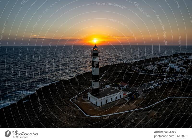 Sunset at Faro d'Artrutx Lighthouse in Menorca sunset faro d'artrutx aerial view lighthouse sea horizon rocky coast menorca spain dusk landscape scenic travel