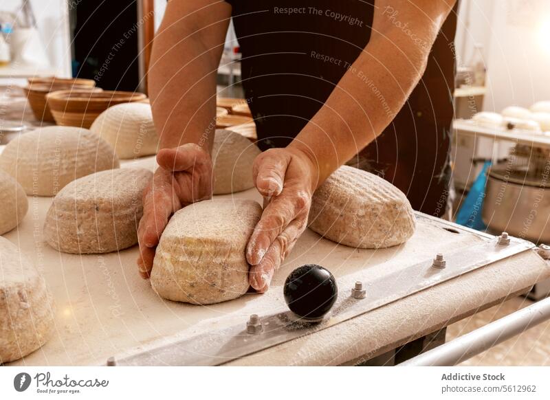 Hands of man making bread in bakehouse baker dough loaf shape hand crop raw flour tray food table kitchen bakery body part fresh handmade chef uncooked