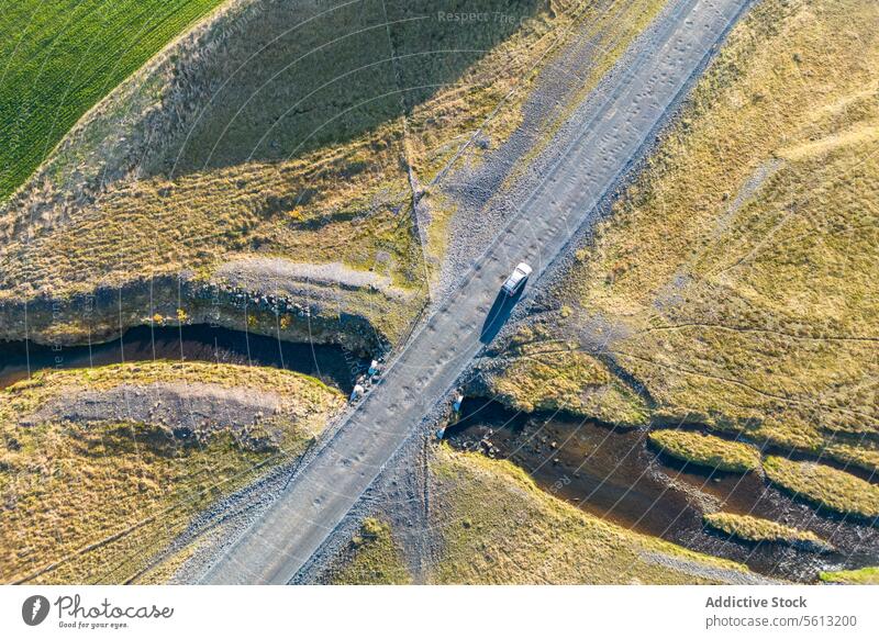 Aerial view of white car on winding road in Thorsmork, Iceland iceland highlands thorsmork aerial view serpentine landscape valley travel nature scenic outdoor