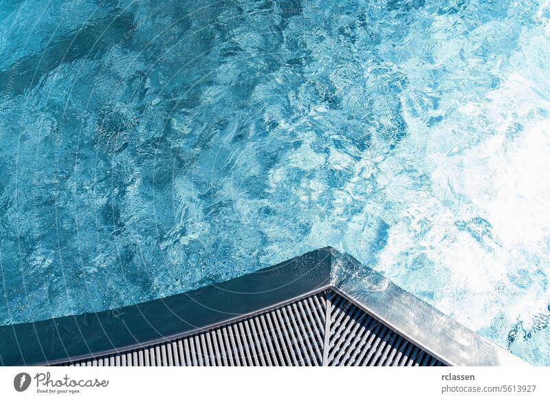 Overhead view of pool corner with textured blue water and grating edge leisure activity water play bright purity water movement water clarity cool wet