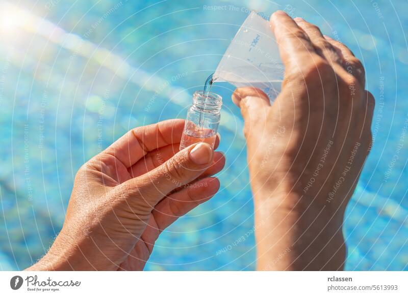 service engineer hands pouring water into testing vial for PH value test against pool background bottling pool water testing water vial chlorine measure sample