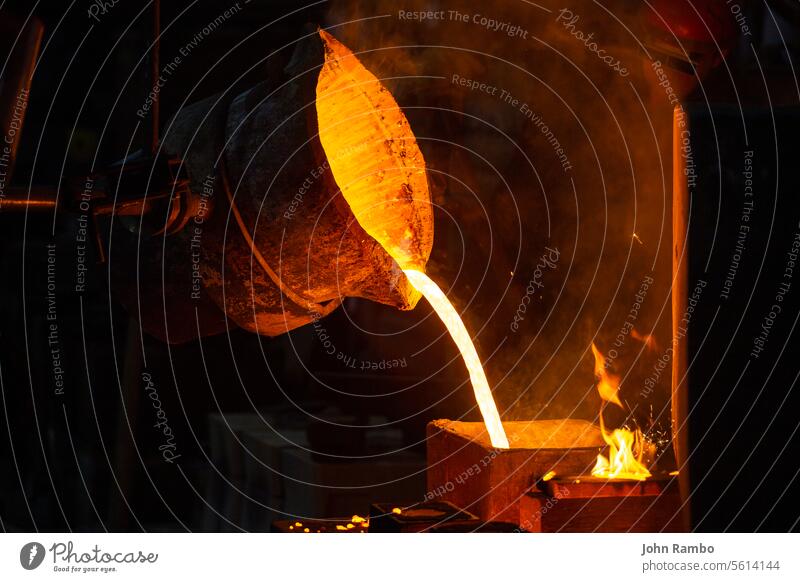 Close-up view of industrial chill casting. The process of for filling out mold with molten metal. pouring selective focus technology model steel hollow foundry