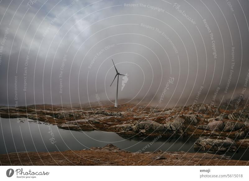 Mountain lake and wind turbine on the Gotthard Pass in gloomy weather full of clouds and fog Switzerland central switzerland mountain lake Alps Water Tourism