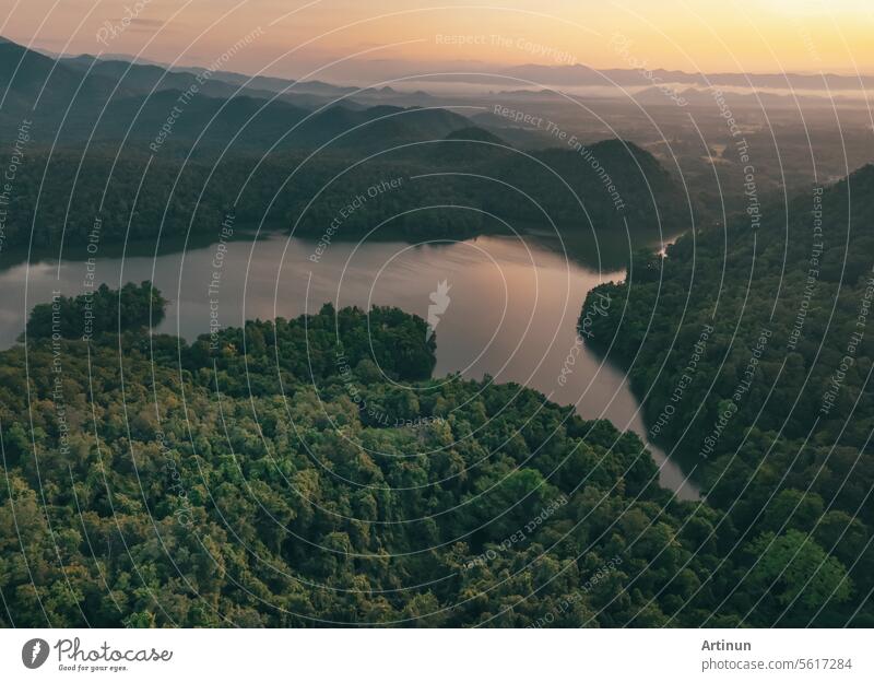 Beautiful landscape of green mountains and lake in the morning with sunrise sky. Nature landscape. Watershed forest. Water and forest sustainability concept. Aerial view of mountain with green trees.