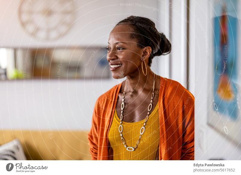 Portrait of a smiling mature woman standing in her apartment people joy black natural attractive black woman happiness happy real people adult daily life adults