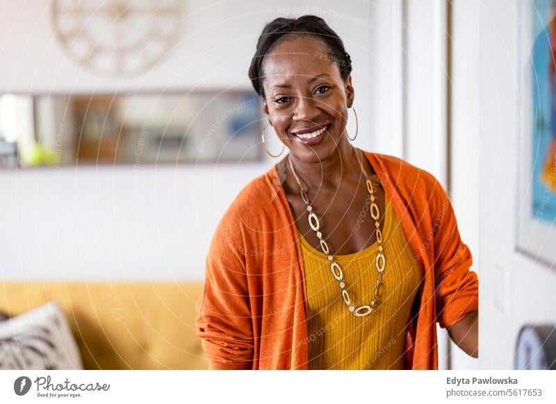 Portrait of a smiling mature woman standing in her apartment people joy black natural attractive black woman happiness happy real people adult daily life adults