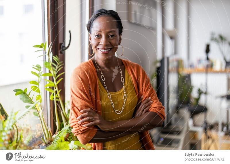 Portrait of a smiling mature woman standing in her apartment people joy black natural attractive black woman happiness happy real people adult daily life adults