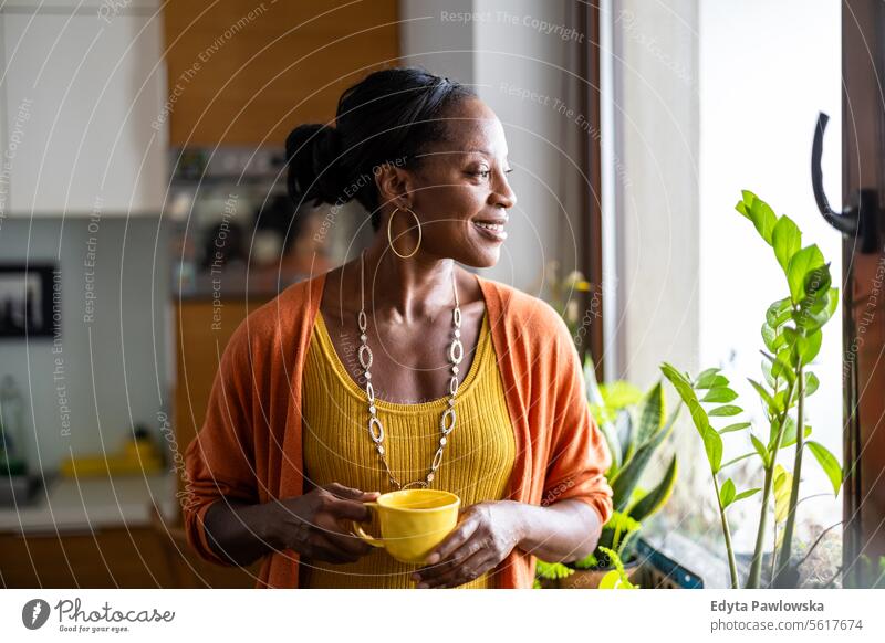 Portrait of a smiling mature woman standing in her apartment people joy black natural attractive black woman happiness happy real people adult daily life adults