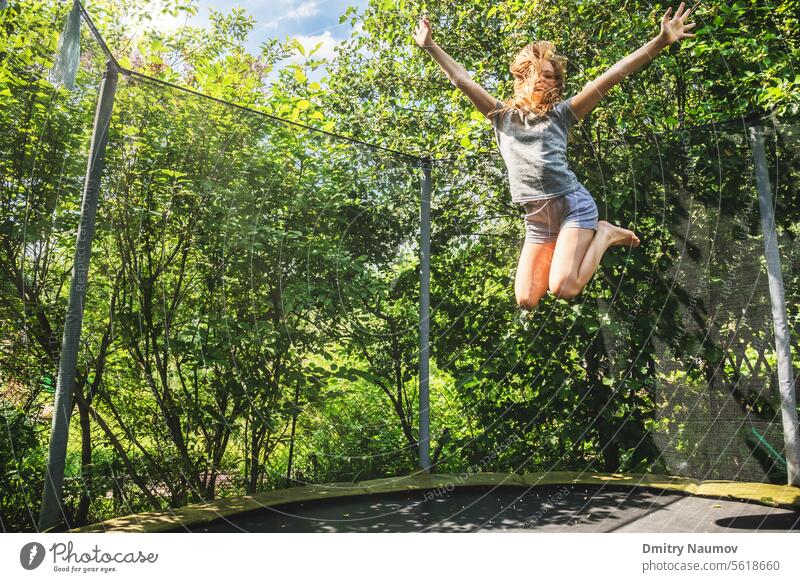 Girl jumping on a trampoline outdoors activity Air Backyard Hop Child Infancy Childish peril Dangerous emotion energetic Energy To enjoy enjoyment Excitement