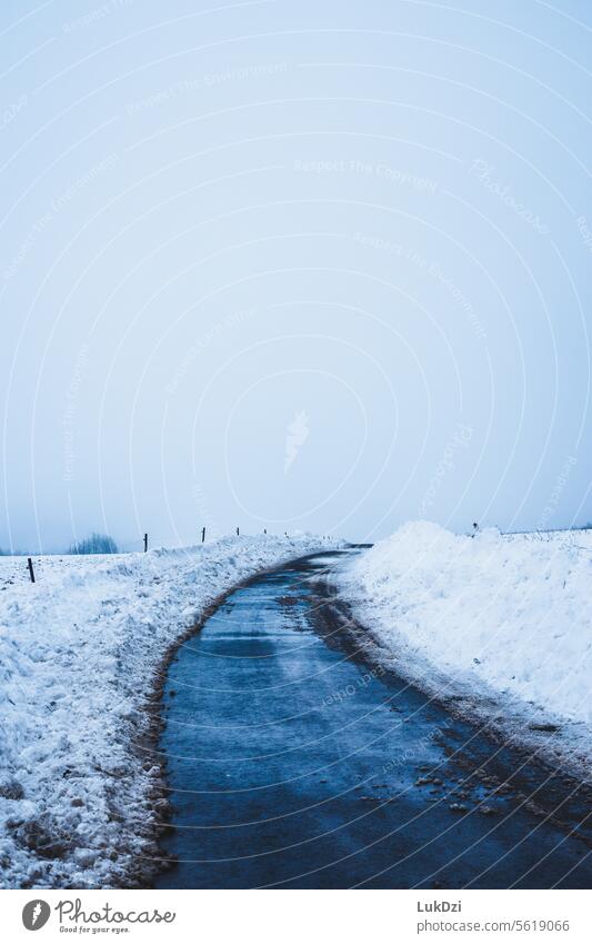 Asphalt road during the winter with no people wintertime way snowfall landscape frost direction cold asphalt Road marking snowed in landscape photography