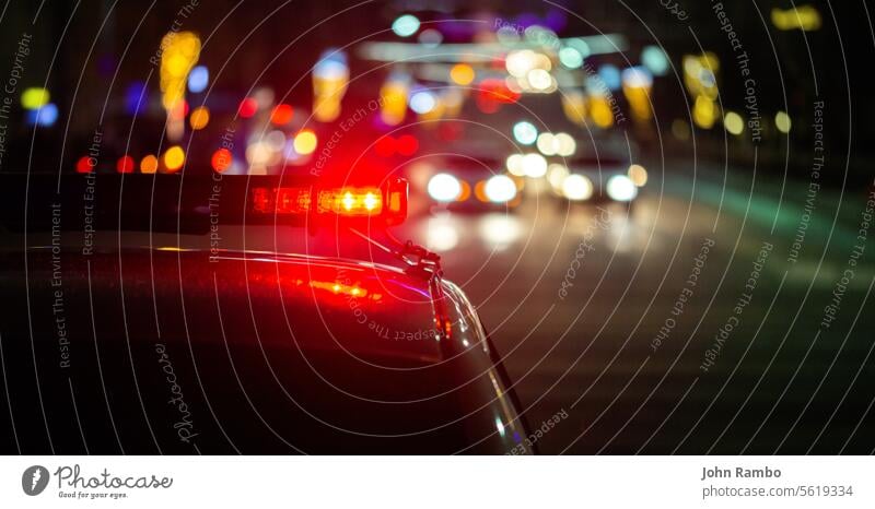 police car lights in night city with selective focus and bokeh abstract accident alarm scene news emergency road crime service red law enforcement urban duty