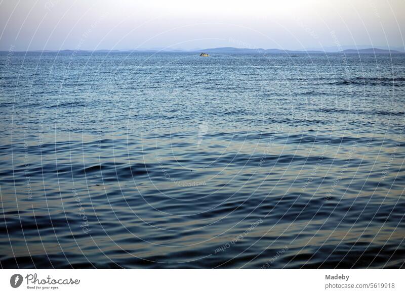 View from the beach in Altinoluk in the romantic light of the setting sun on the Gulf of Edremit on the Aegean Sea in the province of Balikesir in Turkey Golf