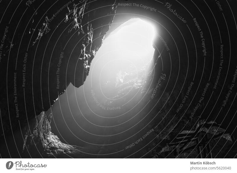 Rock cave with hole through which light shines. Underworlds in Sweden. Mystical sunlight vacation danger national park fascination sweden travel tunnel unique