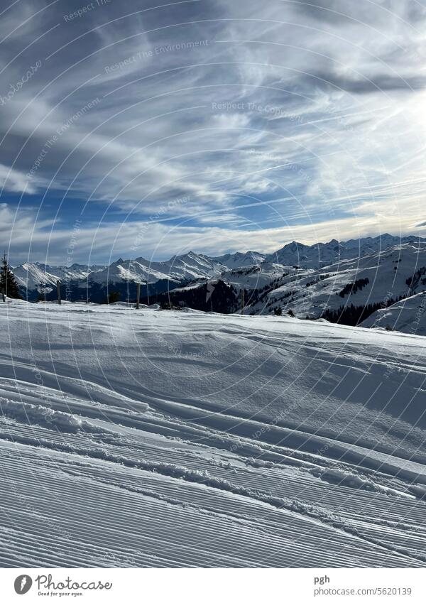 Dreamlike atmosphere in the mountains Mountain mountain landscape Snow Winter Skiing Ski run Snowcapped peak Clouds Ski piste Ski resort skis