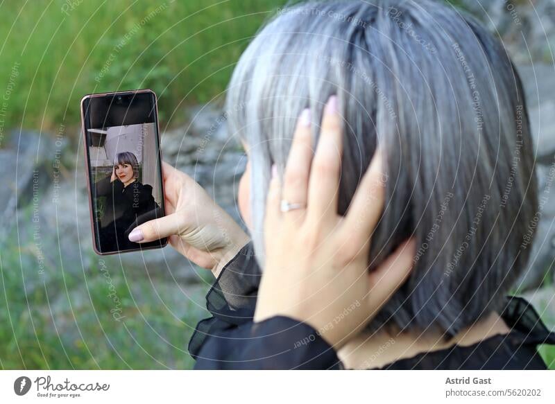 A woman takes a selfie of herself Woman Selfie Self portrait Self-portrait Cellphone smartphone photo Take a photo self-protrait Telephone fun Joy Internet