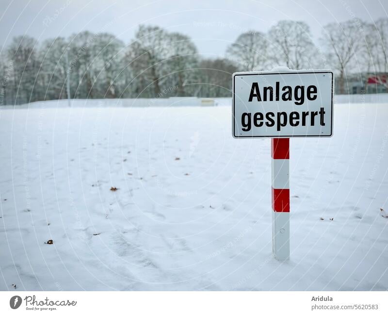 "Facility closed" sign on snow-covered sports field System locked Sporting grounds Winter Snow Barred Signs and labeling Signage Deserted Warning label Safety