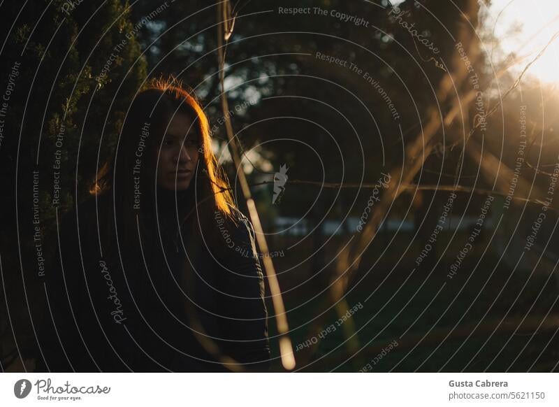 Woman illuminated by the rays of the morning sun. portrait Portrait photograph Shadow rays of the sun Morning Morning fog morning light Exterior shot