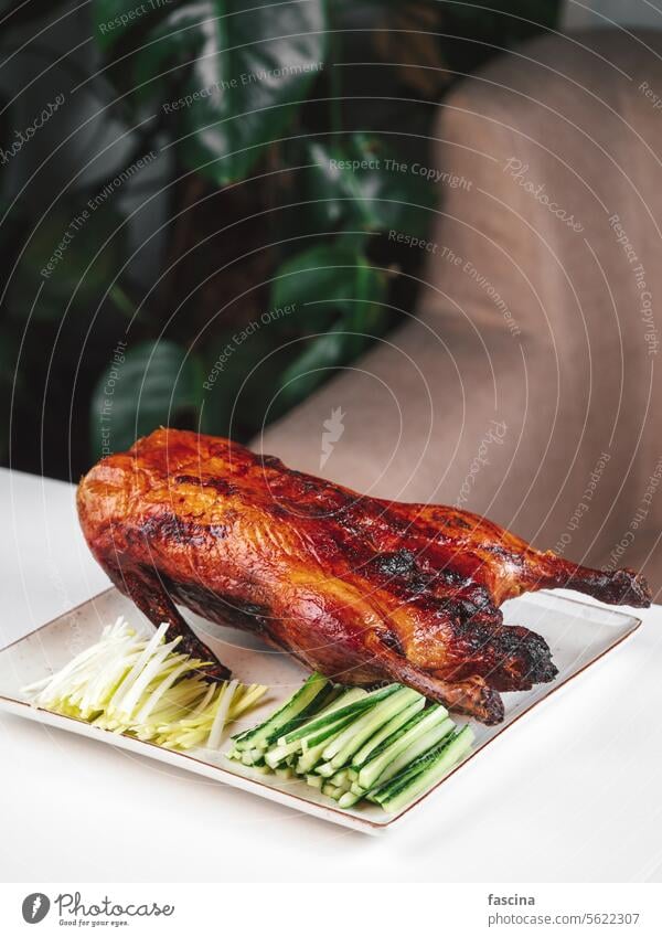 Whole Roasted Peking Duck on Table Peking duck roasted Beijing grilled roasted duck dish crispy savory traditional restaurant food culinary gourmet crispy-skin