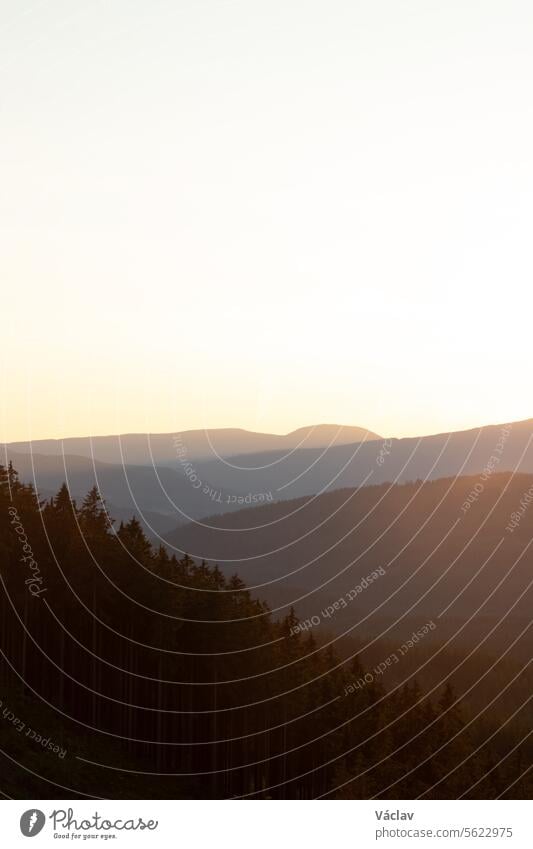 Sun rays in the morning hours shine through the hillsides and mountains in Beskydy mountains, Czech Republic sunset beskid mountains outside colourful sunshine