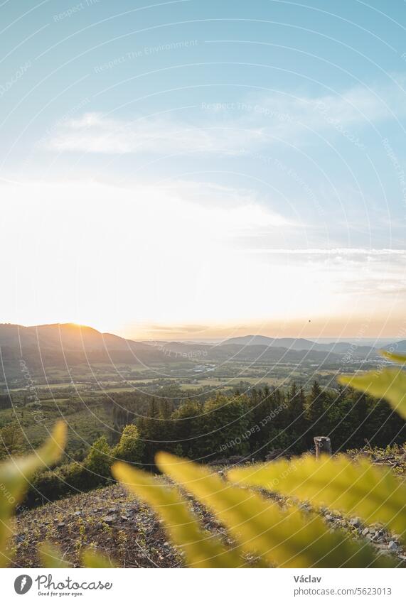 Sunset illuminating the valley around Radhost, Beskydy mountains, Czech Republic. Enchanting nature of central Europe sunset outside colourful sunshine explore