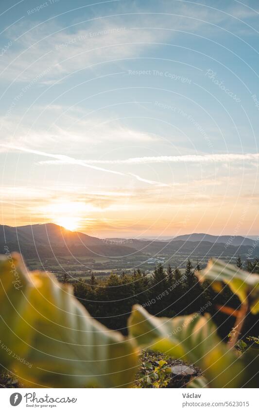 Sunset illuminating the valley around Radhost, Beskydy mountains, Czech Republic. Enchanting nature of central Europe sunset outside colourful sunshine explore