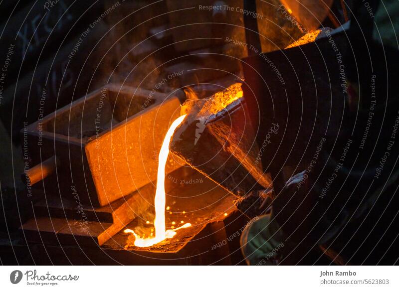 Close-up view of industrial chill casting. The process of for filling out mold with molten metal. pouring selective focus technology model steel foundry fire