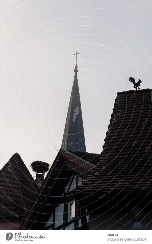 Roofs with church tower, nest and weathercock Church spire Religion and faith Nest Stork's Nest Weathercock Village Sky Haze Building Old town