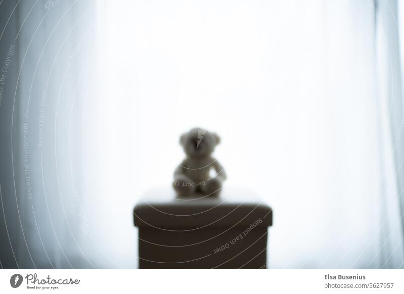 Unsharp cuddly toy blurriness blurred at the window Window Light Stool Seat sad mood Dark Moody Shadow Deserted Day Calm Interior shot Flat (apartment) room