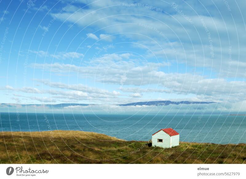 Iceland - small hut in the Westfjords Reykir Fjord Hut refuge Loneliness Ocean Atlantic Ocean Tourism Blog Grassland Clouds Lava Lava rock Ethnic Vacation mood