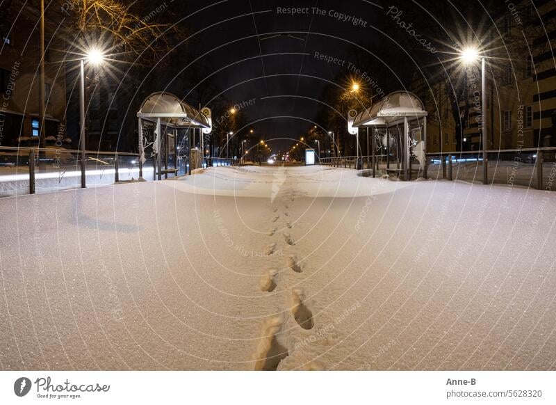 Nothing runs here anymore. Streetcar stop on a winter evening. The tracks are covered in a thick layer of snow, only footprints are visible. Wintertime