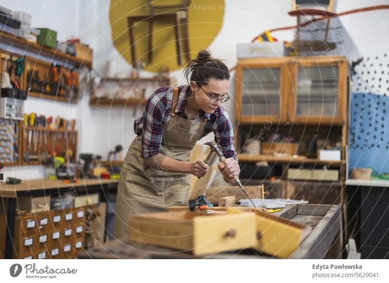 Female carpenter working in her workshop Furniture Carpenter Restoring Carpentry wood Chair building Manufacturing Craft Renovation Repairing Craftsperson