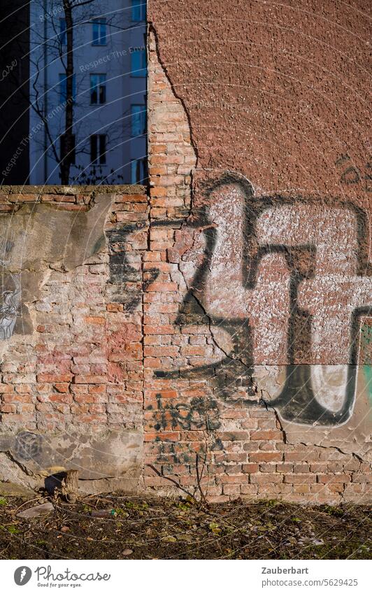 Firewall with chipped plaster and graffiti in the warm light Fire wall Wall (barrier) Plaster structures shape Graffiti street art Town dwell Apartment Building