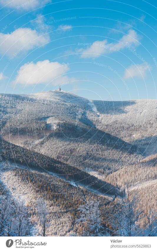 Winter scenery with sun rays reflecting off the glittering snow. Sunrise in a snowy wilderness and woodland. Beskydy mountains, Czech Republic winter scene