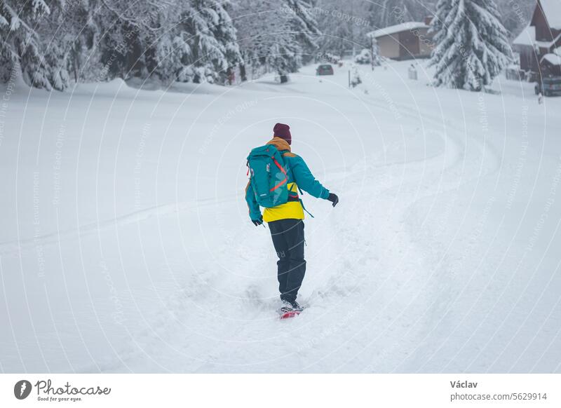 Young athlete snowboarding in free ride in Beskydy mountains, Czech Republic. Snowboarding in wild nature. Freedom of movement wonderland one person adult