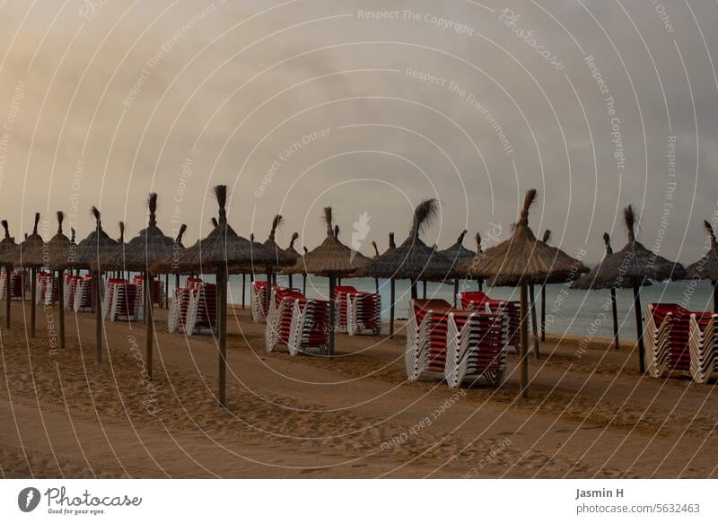 Sea, beach, parasols, stacked sun loungers Beach Ocean Water Sand coast Vacation & Travel Sky Clouds Tourism Exterior shot Deserted vacation Summer Colour photo