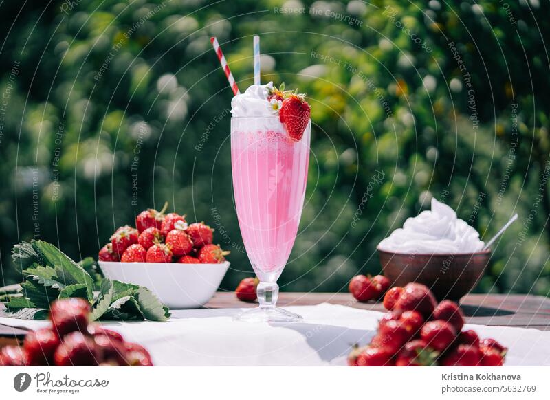 Still life - amazing strawberry milkshake cocktail with straw on nature backdrop beautiful beverage breakfast bright cheerful composition creamy creamy goodness