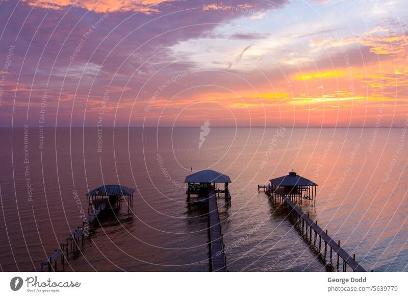 Piers on the bay at sunset at the Gulf Coast, USA pier boardwalk scenic dramatic sky daphne al dusk twilight drone photography summer july mobile bay mobile al