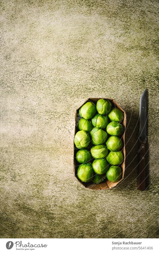 Fresh cabbage sprouts in a box on a green table. Top view. Cabbage sprout Raw Cardboard Food Vegetable Green Healthy Organic Mature Diet naturally Table