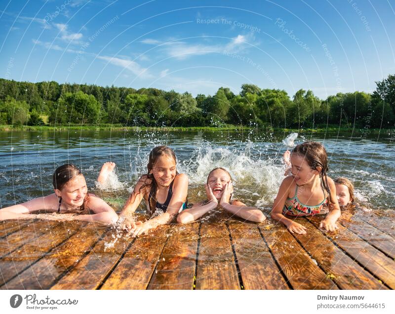 Happy children enjoying summer holidays activity candid carefree childhood deck emotion enjoyment friends friendship fun girls group happiness happy having fun