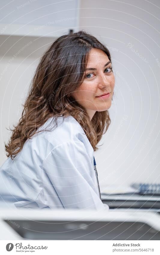 Young female doctor in uniform with stethoscope looking at camera woman portrait smile medical clinic hospital specialist nurse health care physician medicine