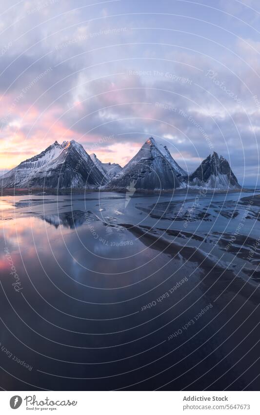 Majestic snow-capped mountains at Icelandic dusk iceland reflection tranquil water sky pastel landscape nature serene peak vista twilight calm outdoor scenery