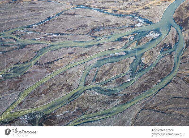 Top view drone image of breathtaking drone view of curvy river estuary amidst mountains in Iceland valley brook ridge creek landscape iceland highland wetland