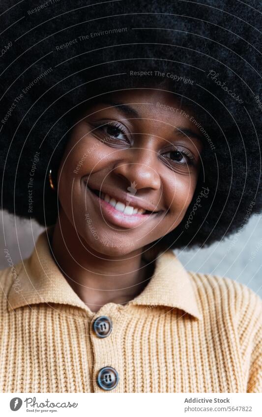 Smiling black woman with Afro hairstyle smile portrait afro appearance individuality personality brown eyes positive curly hair female african american happy